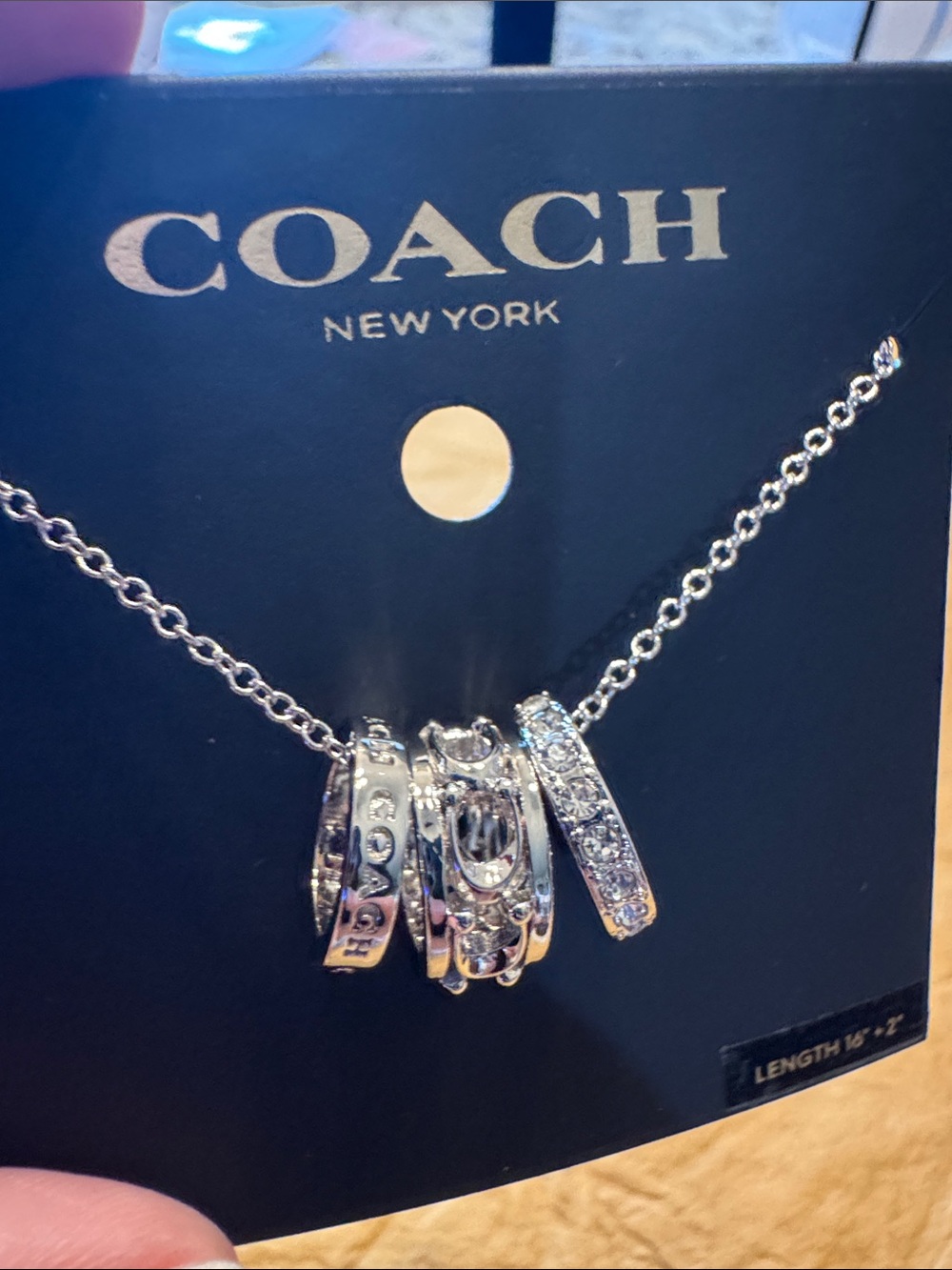 Coach Silver-Tone Multi-Ring Pendant Necklace with Crystal Accents